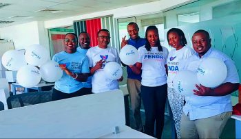 Group photo of Penda Health Staff in Penda Points branded t-shirts during the launch of the customer loyalty prorgam