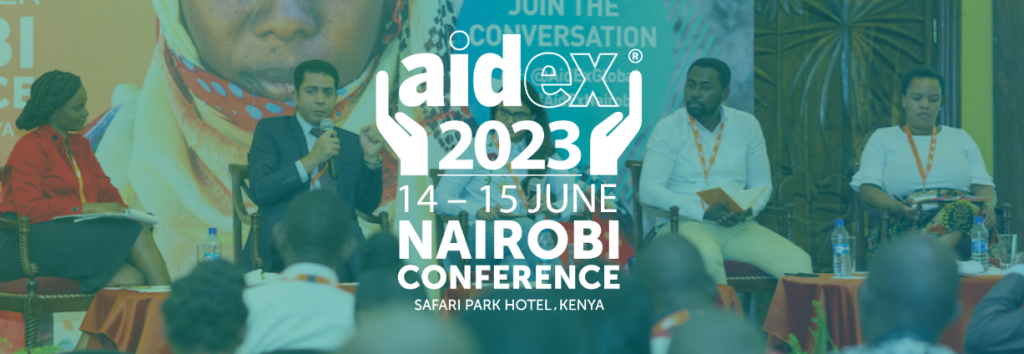 Two men, one woman in a panel discussion with the words Aidex 2023 Nairobi Conference at the forefront